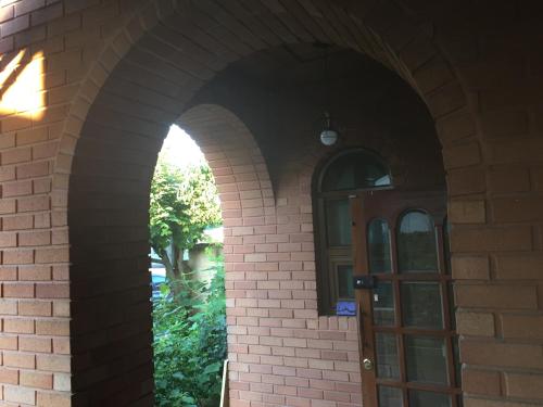 an arched entry way to a brick building with a door at BluePlanet in Gyeongju