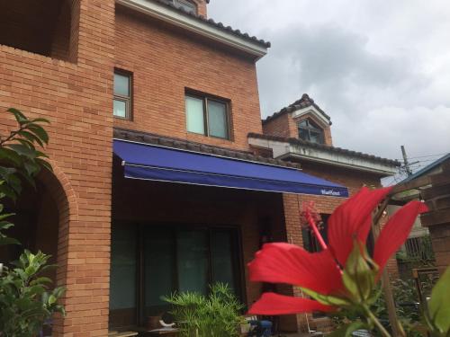 a building with a red flower in front of it at BluePlanet in Gyeongju