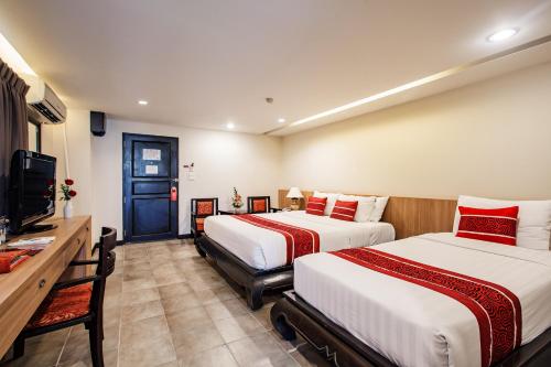 Katil atau katil-katil dalam bilik di Raming Lodge Hotel