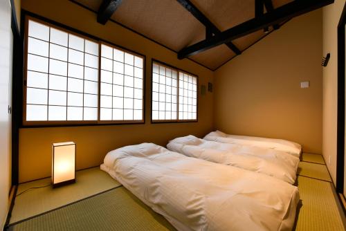 Ένα ή περισσότερα κρεβάτια σε δωμάτιο στο Miro Hachijo Genmachi BeTei