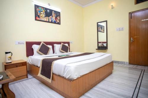 a bedroom with a large bed in a room at Hotel Dimple International in Udaipur