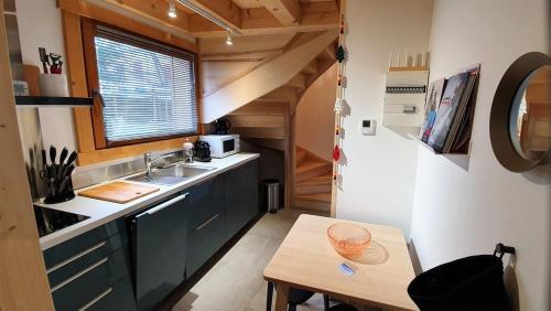 a small kitchen with a sink and a table at Le camp de base in Chamonix-Mont-Blanc