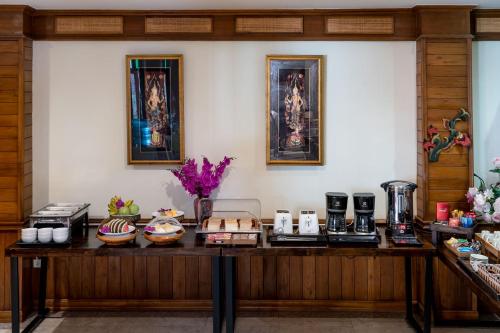 a table with food on it in a room at Lee Chiang Hotel in Chiang Mai