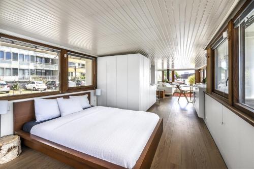 
a bedroom with a bed and a window at Stunning boat with a view in Amsterdam

