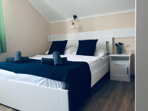 a bedroom with two beds with blue pillows at Bagolyvár Inárcs in Inárcs