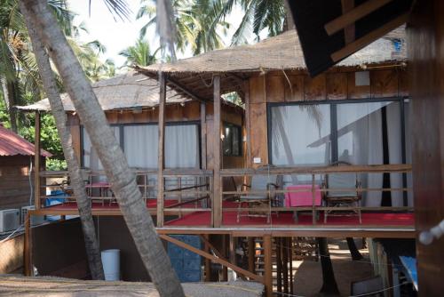 a house under construction with a table and chairs at Magic World in Palolem