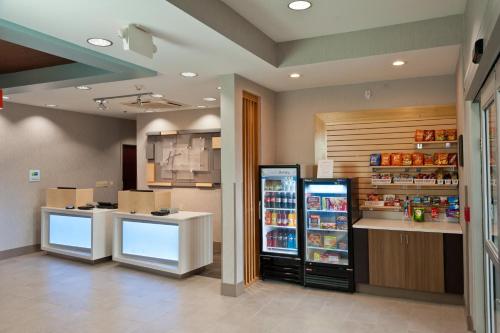 a grocery store with a refrigerator and a counter at Holiday Inn Express Hotel & Suites Scott-Lafayette West by IHG in Scott