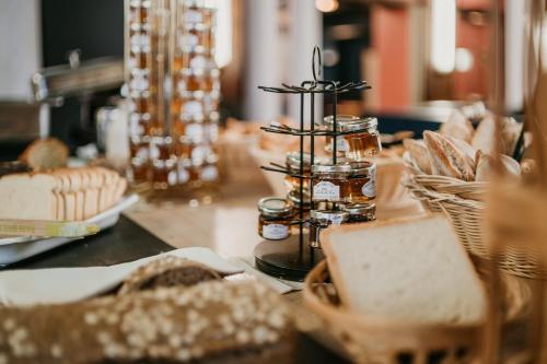 a table topped with jars and plates of food at Grand Hôtel de Valenciennes in Valenciennes