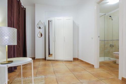 ein Bad mit einem WC, einem Tisch und einer Dusche in der Unterkunft Center Holiday Corralejo in Corralejo