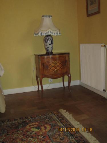a lamp on a table in a room at Chambres d'Hôtes à la Fontanille in Panazol