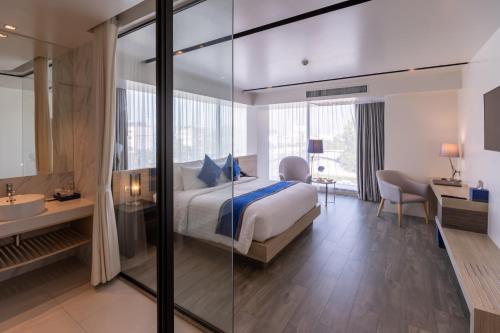 a hotel room with a bed and a bathroom at Wintree City Resort Chiang Mai in Chiang Mai