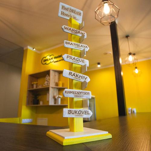 a sign pole with many street signs on it at DREAM Hostel Khmelnytskyi in Khmelʼnytsʼkyy