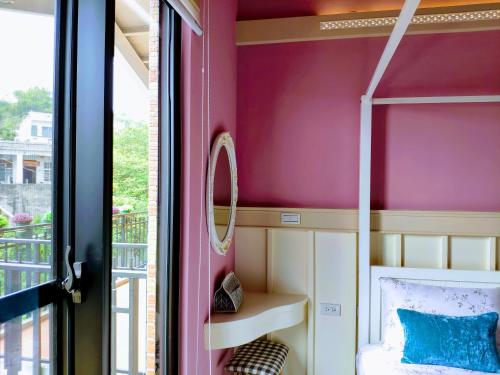 a small room with a bed and a window at Teacher Cai Homeestay in Xiaoliuqiu