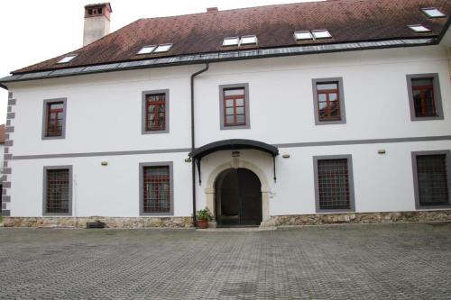 a large white building with a brown roof at Samostan Mekinje in Kamnik
