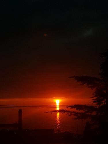 a sunset over a body of water at La mansarda delle meraviglie B&B Superior in Trieste