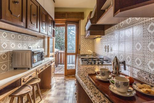 a kitchen with a counter with cups on it at Cantore, Cortina by Short Holidays in Cortina dʼAmpezzo