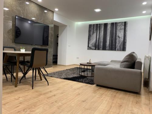 a living room with a couch and a table at BLACK APARTMENT by ALEX RAFAEL in Zagreb