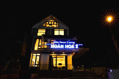 a building with a sign on it at night at Ngan Hoa - Mille Fleurs 02 in Da Lat