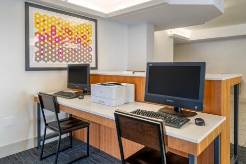 an office with a desk with a computer and two chairs at Holiday Inn Express Cape Coral-Fort Myers Area by IHG in Cape Coral