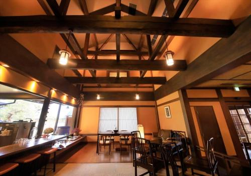 a dining room with tables and chairs in a building at Saikatei Jidaiya in Kaminoyama