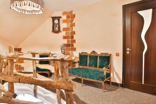 a living room with a table and a green couch at Грибова хата in Bukovel