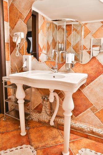 a bathroom with a white sink and a mirror at Грибова хата in Bukovel