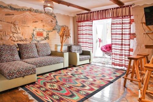 a living room with a couch and a rug at Грибова хата in Bukovel