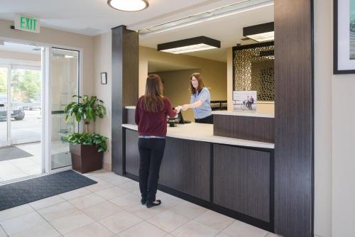 a woman standing at a counter in a dental office at Candlewood Suites Olympia - Lacey by IHG in Lacey