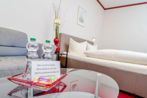 a living room with a bed and a glass table at Gästehaus Engelgasse Herzogenaurach in Herzogenaurach