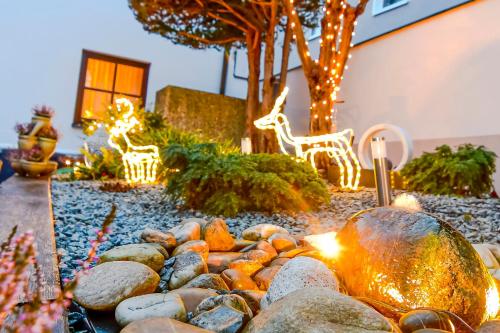 a garden with christmas lights and rocks in a yard at Gästehaus Engelgasse Herzogenaurach in Herzogenaurach