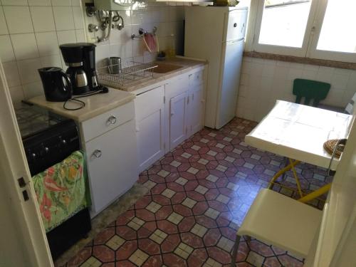 a small kitchen with a sink and a stove at Fisher 46 in Lisbon