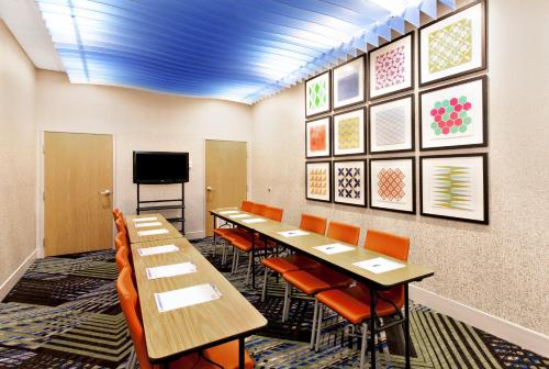 a conference room with tables and chairs and a tv at Holiday Inn Express Lake Wales North-Winter Haven by IHG in Waverly