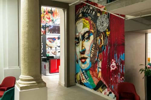a wall with a mural of a woman at T62 Hotel in Budapest