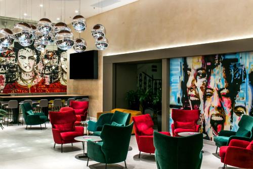 a living room filled with lots of chairs and tables at T62 Hotel in Budapest