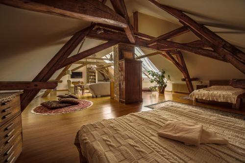 a bedroom with two beds in a attic at Káli Art Inn in Köveskál