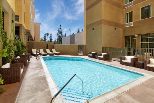 a swimming pool in the middle of a building at Staybridge Suites Anaheim At The Park by IHG in Anaheim