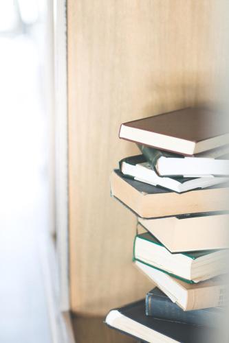 a stack of books sitting on a shelf at B&B Nieuwhof in Gistel