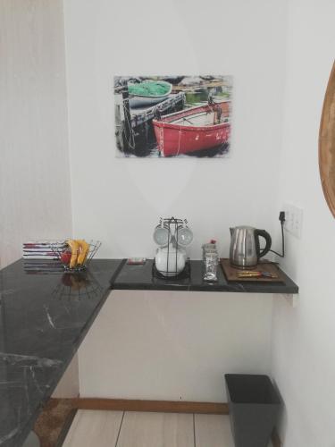 a black counter in a room with a picture on the wall at Rooftops in Bredasdorp
