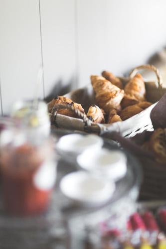 a table with a plate of pastries and other foods at B&B Nieuwhof in Gistel