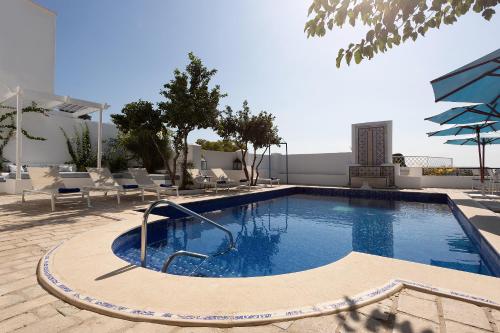 une grande piscine avec des chaises dans l'établissement Dar Said, à Sidi Bou Saïd