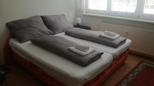 a bed with two towels on top of it at Flat for 2 people, WiFi in Ostrava