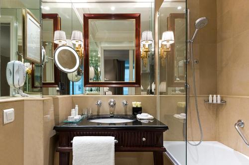 a bathroom with a sink and a shower and a mirror at Francois 1er in Paris