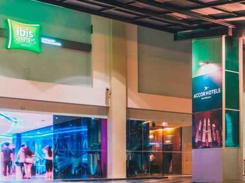 a shopping mall with people walking in front of a store at Ibis Styles Kuala Lumpur Fraser Business Park in Kuala Lumpur
