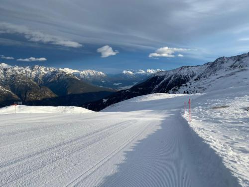 a snow covered mountain with a trail in the snow at Landhaus Zangerl - Kobelerhof in Landeck