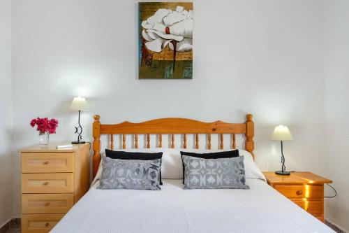 a bedroom with a bed and a painting on the wall at Villa Davyvic in Sant Joan de Labritja