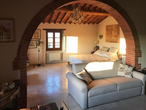 a living room with a bed and a couch at Borgo San Gusmè in San Gusmè