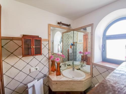 a bathroom with a sink and a mirror at Paradise Villa in Corralejo