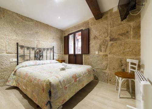 Säng eller sängar i ett rum på Gran Casa Rural A Touza