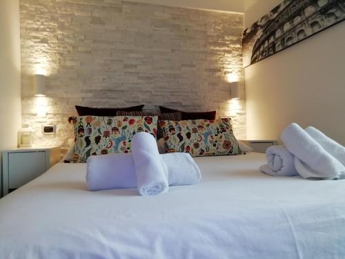 a bedroom with a white bed with two stuffed animals on it at Top floor Tiber View - Trastevere - John Cabot University - Vatican in Rome