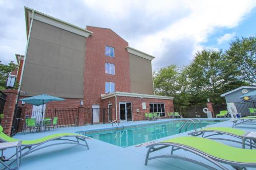 a swimming pool in front of a building at Holiday Inn Express Hotel & Suites Charleston - North, an IHG Hotel in Charleston